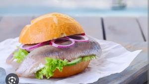 a sandwich with meat and lettuce on a bun at Glücks-Gezeiten in Wurster Nordseeküste