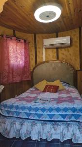 a bed in a small room with a window at Chambre de la Tour 1 in Milhac