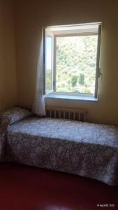 a bedroom with a window with a wedding veil at Casa vacanze Torre in Cefalù
