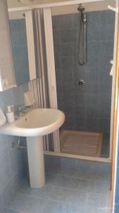 a bathroom with a sink and a shower with a shower at Casa vacanze Torre in Cefalù