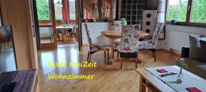 a living room with a table and chairs and a dining room at FeWoFreiZeit in Rheinau