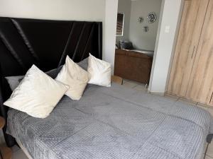 a bedroom with a bed with white pillows on it at The Gather Inn Bethlehem in Bethlehem