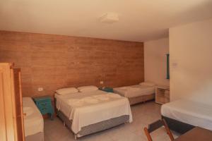 a room with two beds in a room with at Pousada Acqua Bella PISCINA CLIMATIZADA in Bertioga +179 photos