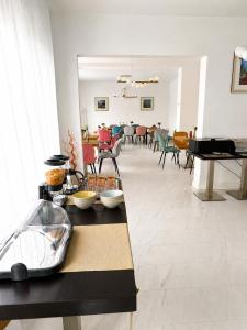 a living room with a table and a piano at Rosetti Inn in Cluj-Napoca