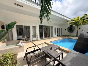 a backyard with a swimming pool and a villa at Pineale Villas, Resort and Spa in Panglao Island