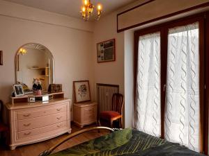 a bedroom with a bed and a dresser and a mirror at La Casa del Benessere in Campobasso