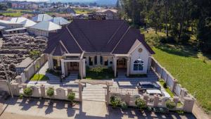 an overhead view of a house with a car in it at Rostel Villa Hotel in Mbeya