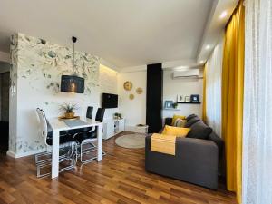 a living room with a couch and a table and a desk at Apartament 14 in Zwierzyniec +12 photos