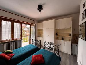 a bedroom with two beds and a window at La Casa del Benessere in Campobasso
