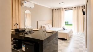 a hotel room with a bed and a desk in a room at BayShore Lofts in Cabo Frio +36 photos