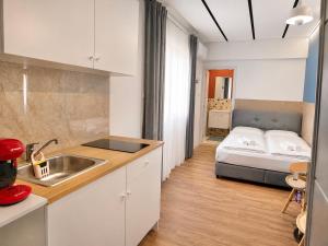 a kitchen with a sink and a bed in a room at Modern Studio 7 private Kitchenette and Bathroom in Limassol