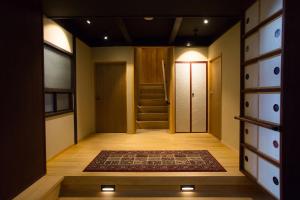 
a living room with a staircase leading to a hallway at Ryokan Mugen (Adult Only) in Kyoto
