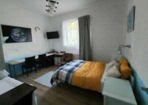 a bedroom with a bed and a desk in it at u Bozeny pokoje in Dźwirzyno