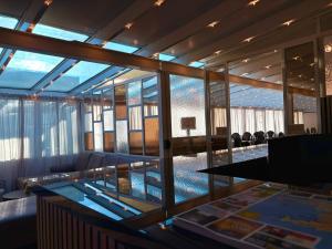 a room with a glass table and a large window at Hotel Hvolsvollur - Central South Iceland in Hvolsvöllur