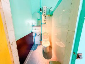 a small bathroom with a toilet and a sink at Social Backpacker Hostel & Rooftop Bar in Battambang +34 photos