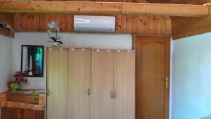 a wooden door in a room with a ceiling at Kamilla Vendégház in Ács