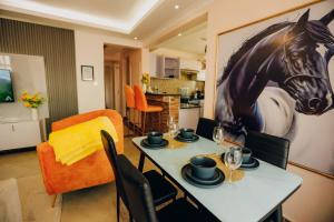 a dining room with a table with a horse on the wall at Rouse precious haven in Nakuru