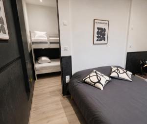a bedroom with a bed with two pillows on it at Le Refuge Gabriel avec grand parking privé in Blois