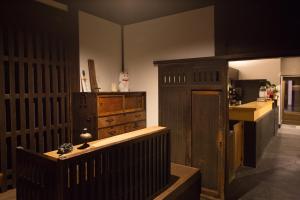 a kitchen with a wooden cabinet and a counter at Ryokan Mugen (Adult Only) in Kyoto