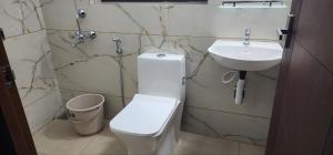 a bathroom with a toilet and a sink at Pearl's Lake House in Cochin