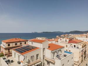 a group of buildings with the ocean in the background at Blue Terrace Guest House in Alghero