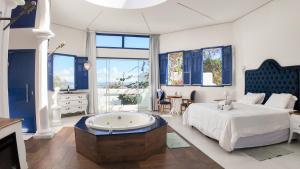 a large bedroom with a bed and a tub at Ilhas Gregas Chalets in Lavras Novas +137 photos