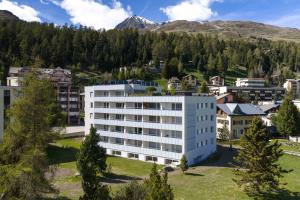 an aerial view of a white building in a city at New Premium Studio with eFireplace, Pool & Sauna in St. Moritz