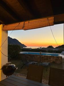 a panoramic view of the sunset from the patio of a house at Villino Giò - Residence Abba Urci in Tertenìa