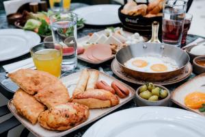 a table topped with plates of breakfast foods and drinks at Elegance East Hotel in Antalya