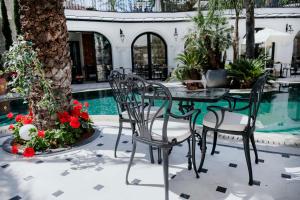 a patio with a table and chairs next to a pool at Elegance East Hotel in Antalya