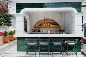an outdoor bar with green tile and stools at Elegance East Hotel in Antalya