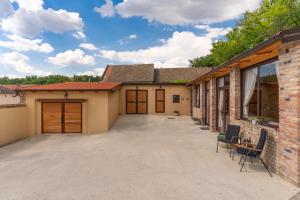 a garage with a large driveway in front of a house at Bogdanović Winery Apartman in Ilok