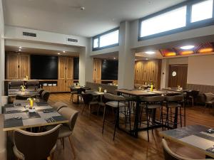 a dining room with tables and chairs and windows at Silken Rona Dalba in Salamanca