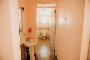 a small bathroom with a toilet and a sink at Rouse precious haven in Nakuru