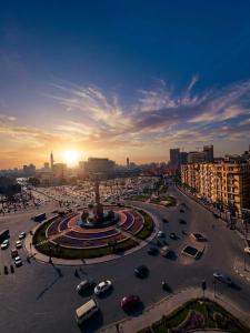 a city with cars parked in a parking lot at Aura Downtown Suites in Cairo