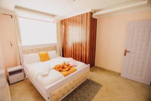 a bedroom with a bed with a towel on it at Rouse precious haven in Nakuru