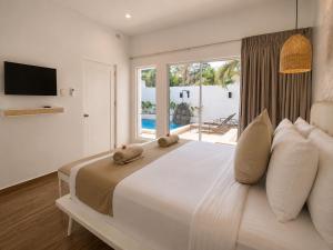 a bedroom with a large white bed and a window at Pineale Villas, Resort and Spa in Panglao Island +105 photos