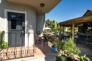 a patio with chairs and tables on a house at No 14 HOTEL GÖCEK in Göcek