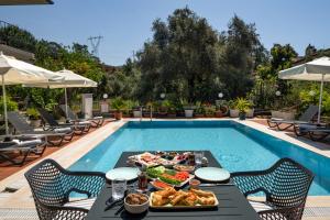 a meal on a table next to a swimming pool at No 14 HOTEL GÖCEK in Göcek