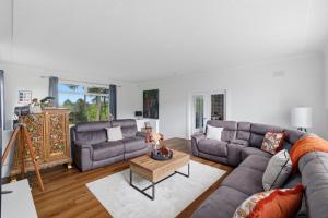 a living room with two couches and a coffee table at Five Marches - Poolside Stays with Stunning Views in Angus