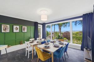 a dining room with green walls and a table and chairs at Five Marches - Poolside Stays with Stunning Views in Angus +40 photos