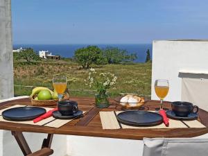 a wooden table with plates and glasses of wine at ÉLYSÉE Boutique in Katavatí