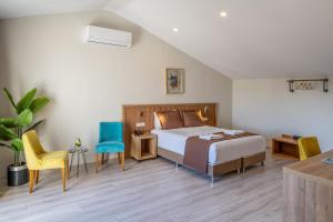 a bedroom with a bed and a table and chairs at No 14 HOTEL GÖCEK in Göcek +16 photos