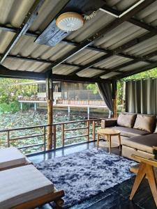 a living room with a couch and a table at Lake side villa in Ko Phangan