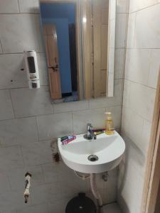 a bathroom with a white sink and a mirror at Shashtri nagar AC homestay in Kolhapur +14 photos