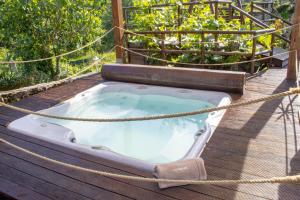 a hot tub on a deck with a rope at Fulão Nature Living in Barcelos