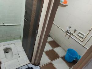 a bathroom stall with a toilet in a bathroom at Shashtri nagar AC homestay in Kolhapur