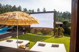 a large screen in a backyard with two mattresses at Fulão Nature Living in Barcelos +32 photos