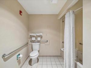 a bathroom with a toilet and a shower at Hotel Blue Baytown, Texas in Baytown