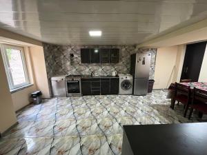 a kitchen with a stove and a refrigerator at Mtskheta Oasis Garden in Mtskheta +10 photos
